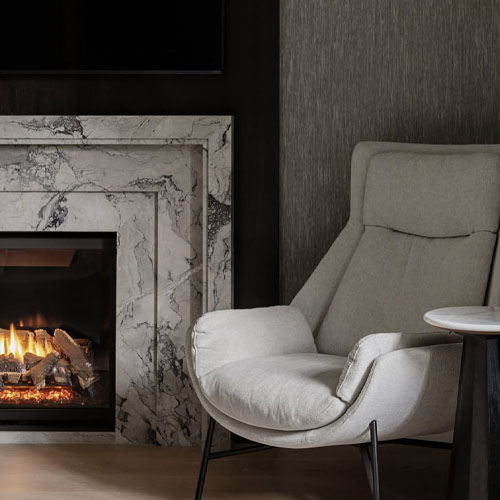 1768528649844970.jpg marble fireplace mantel and chair.jpg